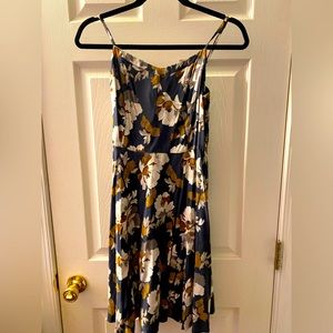 A flowy blue dress with gold and white flowers